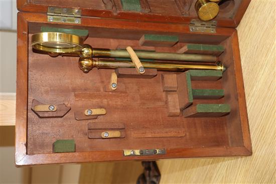 A Victorian brass scientific microscope by Ross, London, boxed with a case of slides